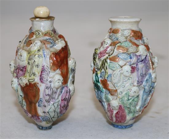 Two Chinese moulded famille rose eighteen luohan snuff bottles, Qianlong marks, but 1821-50, height 7.2cm, one with rim chips